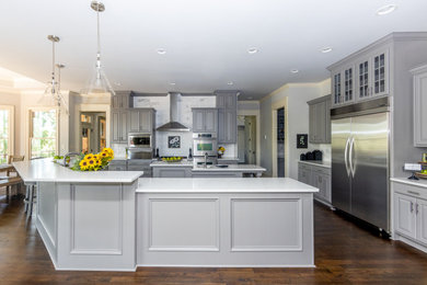Kitchen - huge farmhouse dark wood floor and brown floor kitchen idea in Atlanta with raised-panel cabinets, gray cabinets, quartz countertops, white backsplash, marble backsplash, stainless steel appliances, two islands and white countertops