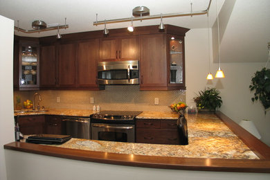 Example of a mid-sized trendy eat-in kitchen design in Other with shaker cabinets, dark wood cabinets, granite countertops, an undermount sink, glass tile backsplash and stainless steel appliances