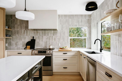 Mid-sized trendy u-shaped light wood floor and beige floor eat-in kitchen photo in Vancouver with a single-bowl sink, shaker cabinets, medium tone wood cabinets, quartz countertops, gray backsplash, porcelain backsplash, stainless steel appliances, an island and white countertops