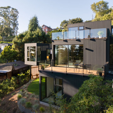 Three-level hillside new construction with rooftop deck, glass railing