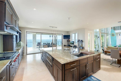 Eat-in kitchen - large transitional u-shaped travertine floor and beige floor eat-in kitchen idea in Miami with an undermount sink, recessed-panel cabinets, dark wood cabinets, granite countertops, beige backsplash, mosaic tile backsplash, stainless steel appliances, an island and beige countertops
