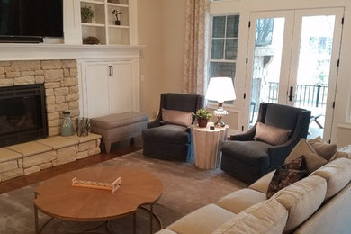 Inspiration for a timeless family room remodel in Cincinnati with a stone fireplace and a wall-mounted tv