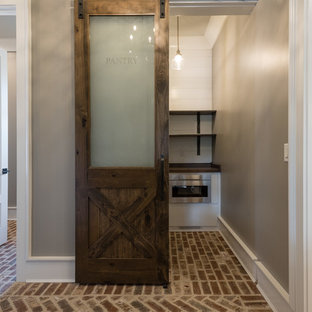 Small country l-shaped kitchen pantry in Atlanta with white cabinets, stainless steel appliances, brown floor, open cabinets, wood benchtops, white splashback, timber splashback, brick floors and no island.