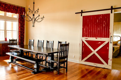Large country medium tone wood floor and brown floor great room photo in Denver with beige walls and no fireplace