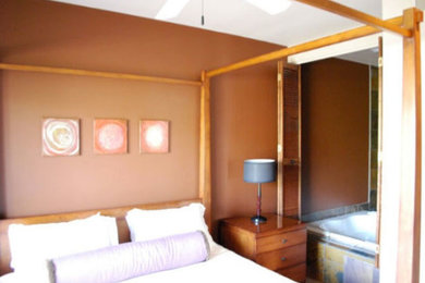 Large master bedroom photo in Phoenix with brown walls