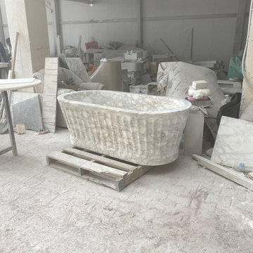 Sculptural Calacatta Gold Marble Bathroom with Hand-Carved Bathtub