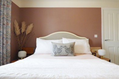 Small bohemian master bedroom in Other with pink walls, carpet and beige floors.