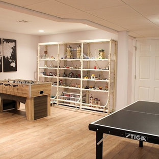 Inspiration for a large traditional look-out basement in Other with purple walls, laminate floors, no fireplace and brown floors.