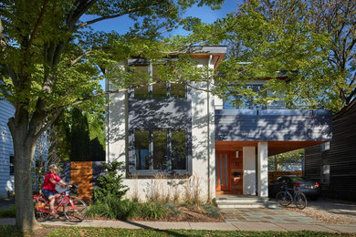 Inspiration for a mid-sized contemporary white two-story stucco house exterior remodel in Philadelphia with a hip roof and a shingle roof