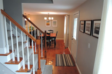 Inspiration for a mid-sized timeless u-shaped dark wood floor eat-in kitchen remodel in Boston with a double-bowl sink, raised-panel cabinets, medium tone wood cabinets, granite countertops, beige backsplash, glass tile backsplash and a peninsula