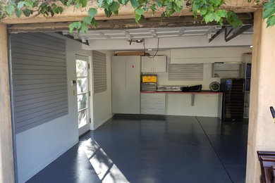 Inspiration for a mid-sized transitional attached one-car garage workshop remodel in Los Angeles