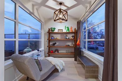 Home office - small contemporary light wood floor home office idea in Calgary with white walls