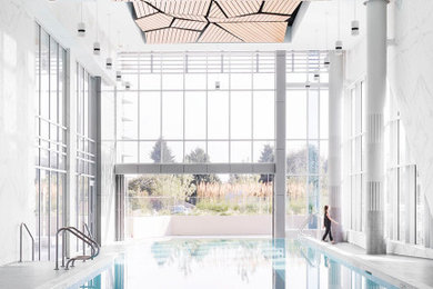 Imagen de casa de la piscina y piscina elevada contemporánea extra grande interior y a medida