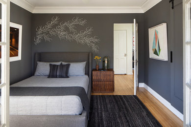 Inspiration for a mid-sized modern master light wood floor and brown floor bedroom remodel in San Francisco with gray walls
