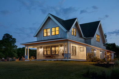 Photo of a large beach style two-storey grey house exterior in Providence with wood siding, a gable roof and a shingle roof.
