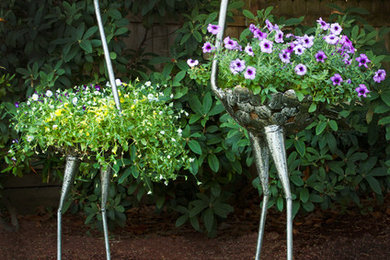 Design ideas for a large eclectic backyard landscaping in Grand Rapids for summer.