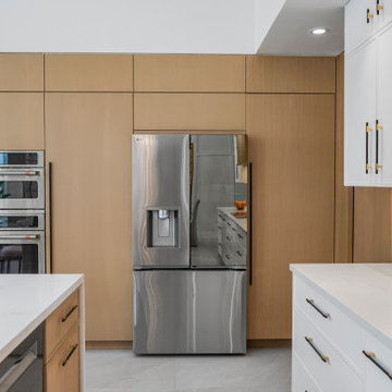 Dual Ovens and Refrigerator Wall with Seamless Paneling