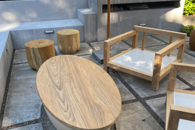 Inspiration for a large modern courtyard concrete patio remodel in Portland with a fire pit