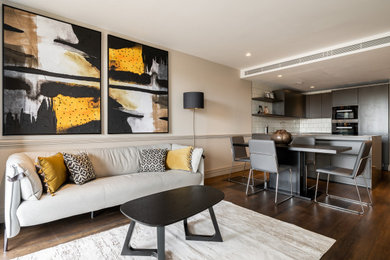 Inspiration for a small contemporary open plan living room in London with beige walls, dark hardwood flooring, brown floors and panelled walls.