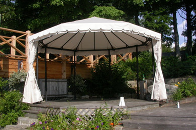 Dock - large rustic backyard dock idea in Toronto with an awning