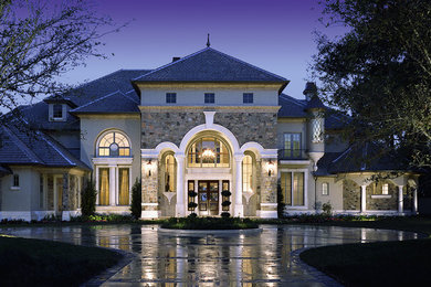 Large elegant gray three-story mixed siding exterior home photo in Orlando