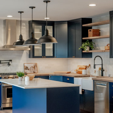 Industrial Matte Black Pendant Lighting over Navy Kitchen Island