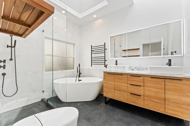 Large minimalist master white tile and ceramic tile cement tile floor, black floor and double-sink bathroom photo in San Francisco with flat-panel cabinets, medium tone wood cabinets, a one-piece toilet, white walls, a vessel sink, quartzite countertops, white countertops and a built-in vanity