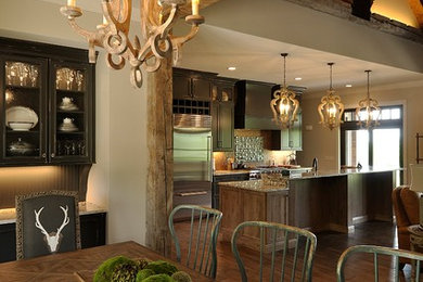 Great room - rustic dark wood floor great room idea in Nashville with beige walls and a stone fireplace
