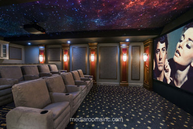 Example of a mid-sized classic enclosed carpeted and multicolored floor home theater design in Philadelphia with gray walls and a projector screen