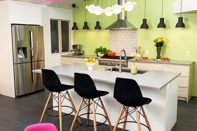 Inspiration for a contemporary eat-in kitchen in San Francisco with an undermount sink, flat-panel cabinets, quartz benchtops, green splashback, stainless steel appliances, porcelain floors, with island, grey floor and grey benchtop.