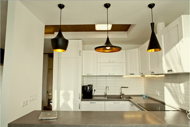 Open concept kitchen - small contemporary u-shaped ceramic tile open concept kitchen idea in Other with an undermount sink, white cabinets, quartzite countertops, white backsplash, ceramic backsplash, stainless steel appliances and a peninsula