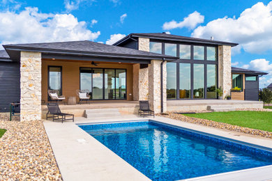Inspiration for a large transitional backyard concrete patio remodel in Other with a roof extension