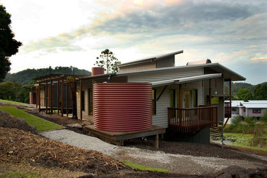 This is an example of a modern two-storey exterior in Gold Coast - Tweed with wood siding.