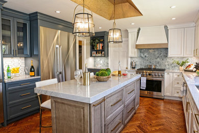 This is an example of a large transitional u-shaped eat-in kitchen in New York with an undermount sink, recessed-panel cabinets, quartzite benchtops, blue splashback, stone tile splashback, stainless steel appliances, medium hardwood floors, with island, brown floor, beige benchtop and recessed.