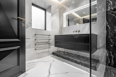 Modern ensuite bathroom in Other with beaded cabinets, black cabinets, white tiles, porcelain tiles, white walls, porcelain flooring, a built-in sink, granite worktops, white floors, white worktops, a single sink and a floating vanity unit.