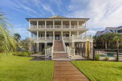 Inspiration for a coastal white three-story brick exterior home remodel in Charleston