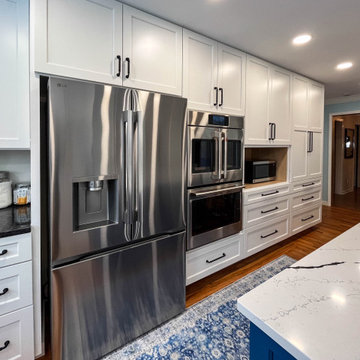 Kitchen with White Perimeter and Blue Island Cabinet Reface