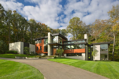 Large modern multicolored three-story wood exterior home idea in Cleveland