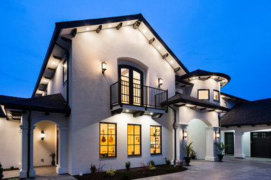 Large transitional white two-story stucco house exterior photo in Other with a hip roof and a shingle roof
