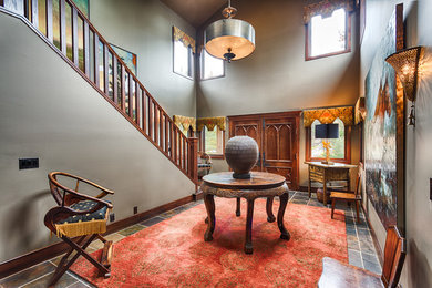 Entryway - large traditional slate floor entryway idea in Calgary with beige walls and a dark wood front door