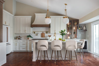 Transitional l-shaped dark wood floor, brown floor and vaulted ceiling kitchen photo in St Louis with shaker cabinets, white cabinets, white backsplash, white appliances, an island and white countertops