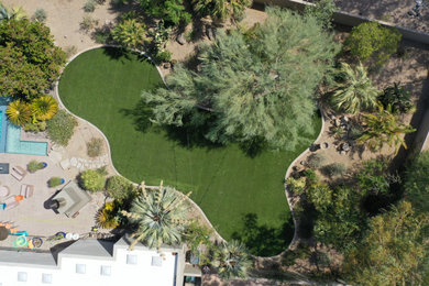 This is an example of a mid-sized tropical drought-tolerant and full sun backyard landscaping in Phoenix.
