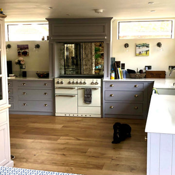 Hand painted grey kitchen with fridge surround and mirrored splash back