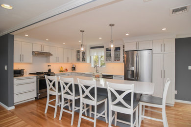 Example of a kitchen design in Boston with white cabinets and white countertops