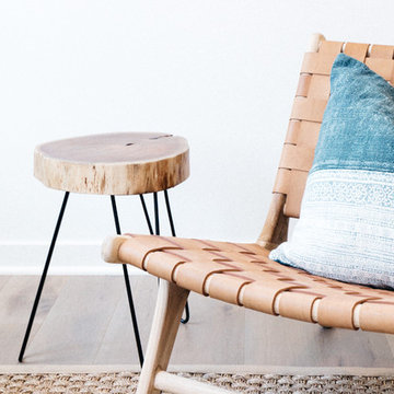 Woven Leather Chair with Batik Pillow and Tree Trunk Side Table
