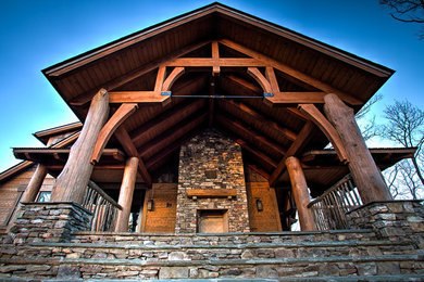 Example of a huge mountain style brown two-story wood gable roof design in Charlotte