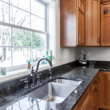 Natural Cherry Shaker kitchen with dark granite countertops