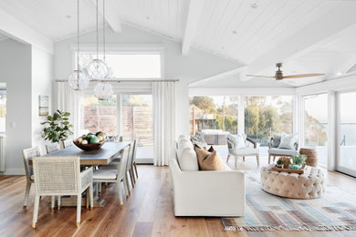Inspiration for a mid-sized beach style formal open concept living room in San Francisco with grey walls, medium hardwood floors, brown floor and no tv.