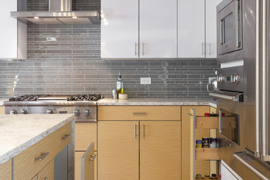 Open concept kitchen - large modern l-shaped medium tone wood floor open concept kitchen idea in Chicago with an undermount sink, flat-panel cabinets, white cabinets, marble countertops, gray backsplash, subway tile backsplash, stainless steel appliances and an island