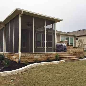 Flagstone patio w/ sandstone walls and screen room w/ sliding doors